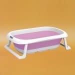 Foldable baby silicone bath tub in a bright color, featuring a non-slip surface and flexible walls for safe, comfortable, and space-saving infant baths.