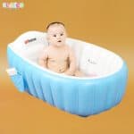 Inflatable bath tub designed for babies, featuring soft, durable walls for safety and comfort, with a visible drain plug and suction cup for easy drying.