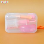 Comprehensive baby medical kit containing colorful dropper, digital thermometer, finger brush, nasal aspirator, and fun adhesive bandages, all neatly organized in a child-friendly, portable case.