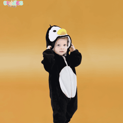 A baby dressed in a cute penguin costume, featuring a soft, black and white bodysuit with an attached hood that has penguin eyes and a beak. The costume is designed for comfort and warmth, making it perfect for a chilly Halloween night or a themed party.